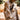 A bronze-colored statue of Jesus Christ in a kneeling, pointing pose, in Angela Johnson's work Neither Do I Condemn You, set outdoors on a stone patio with blurred trees in the background.