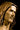 A close-up of a sculpted bust of Jesus Christ with long hair and a beard, in Angela Johnson's work Come Unto Me,shown in warm bronze and brown tones against a dark background.