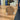 O My Father bronze coin on a stand in front of a laptop on a wooden desk